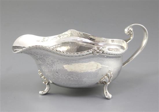 A George V Arts & Crafts silver sauce boat, by Albert Edward Jones, length 185mm, weight 7.3oz/228grms.